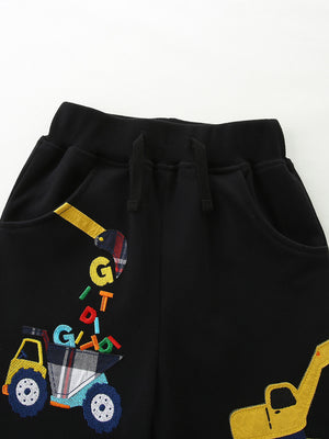 Black cotton baby shorts with excavator print and colorful letter details.