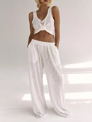 White cropped tank top with twisted detail and matching wide-leg lounge pants.