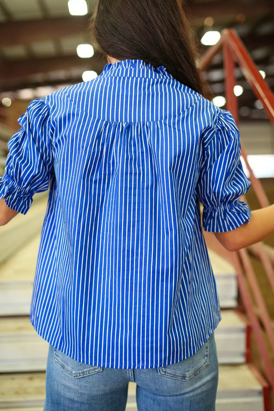 Blue striped cotton blend shirt with ruffled puff sleeves and button placket.