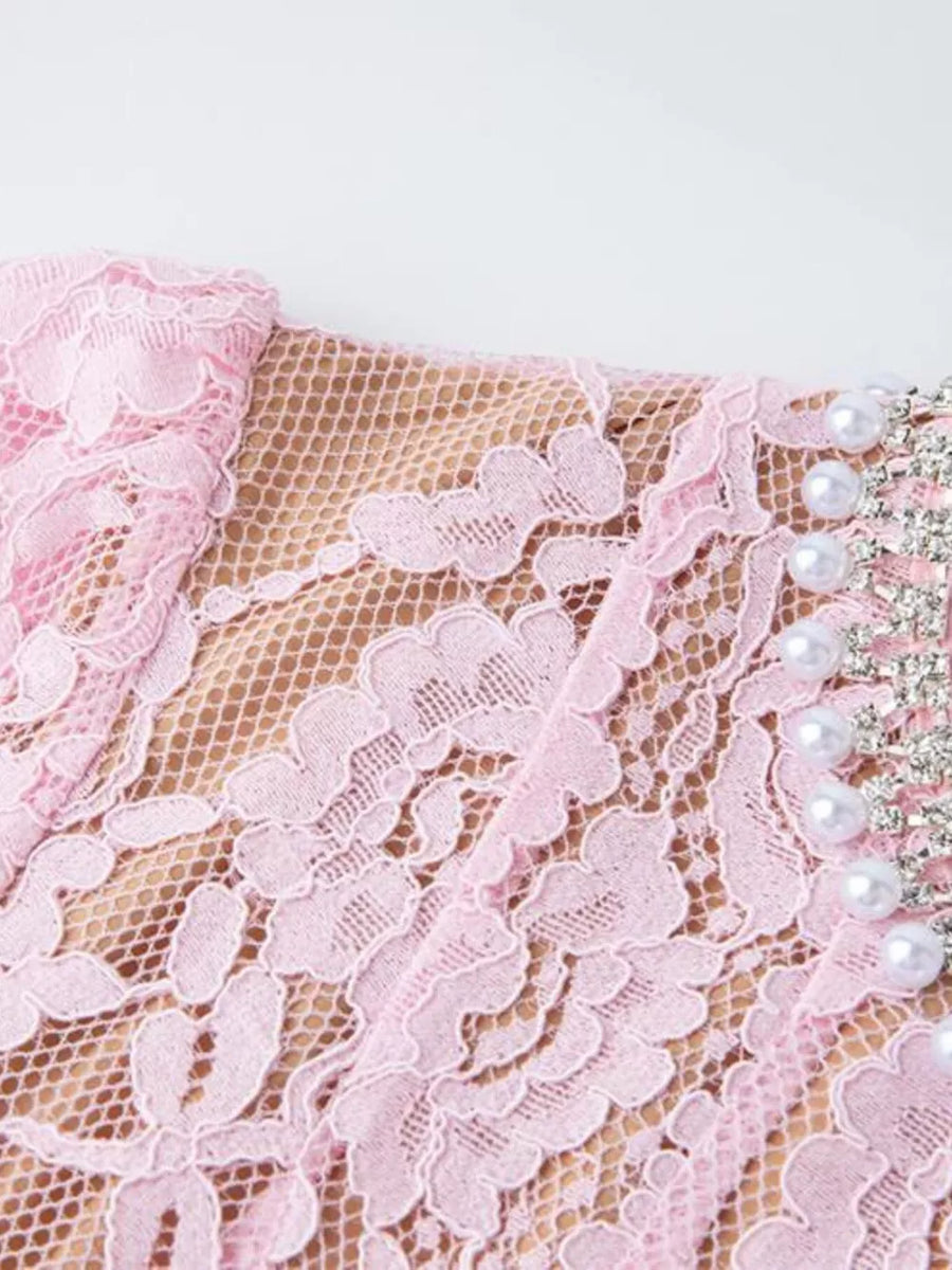 Pink lace dress with pearl and rhinestone embellishments on neckline