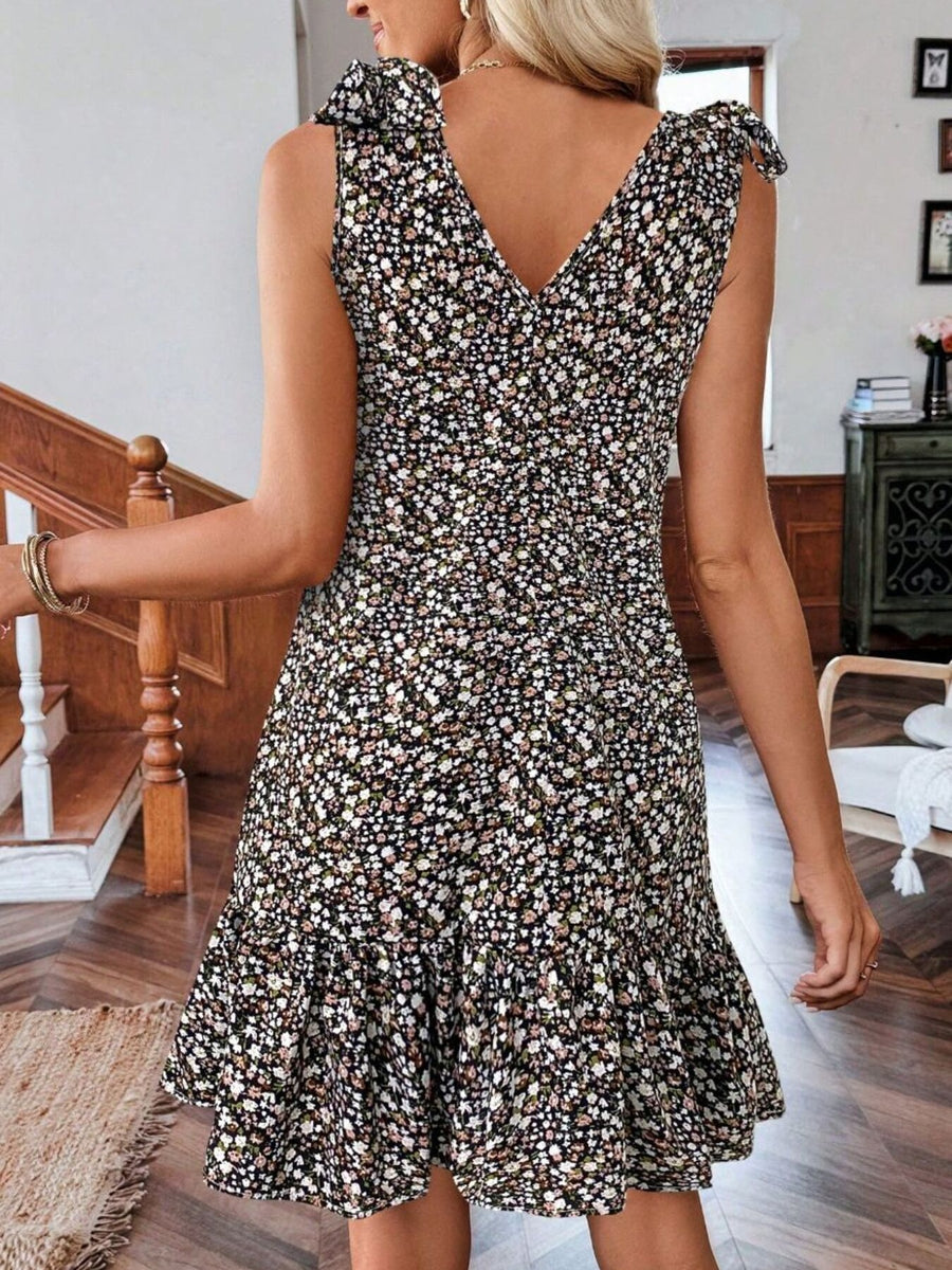 Floral tie strap mini dress with ruffled hem and V-neckline.