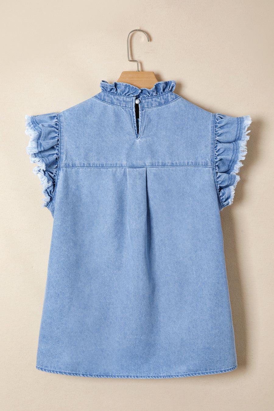 Light blue distressed denim top with frilled collar and ruffled cap sleeves.