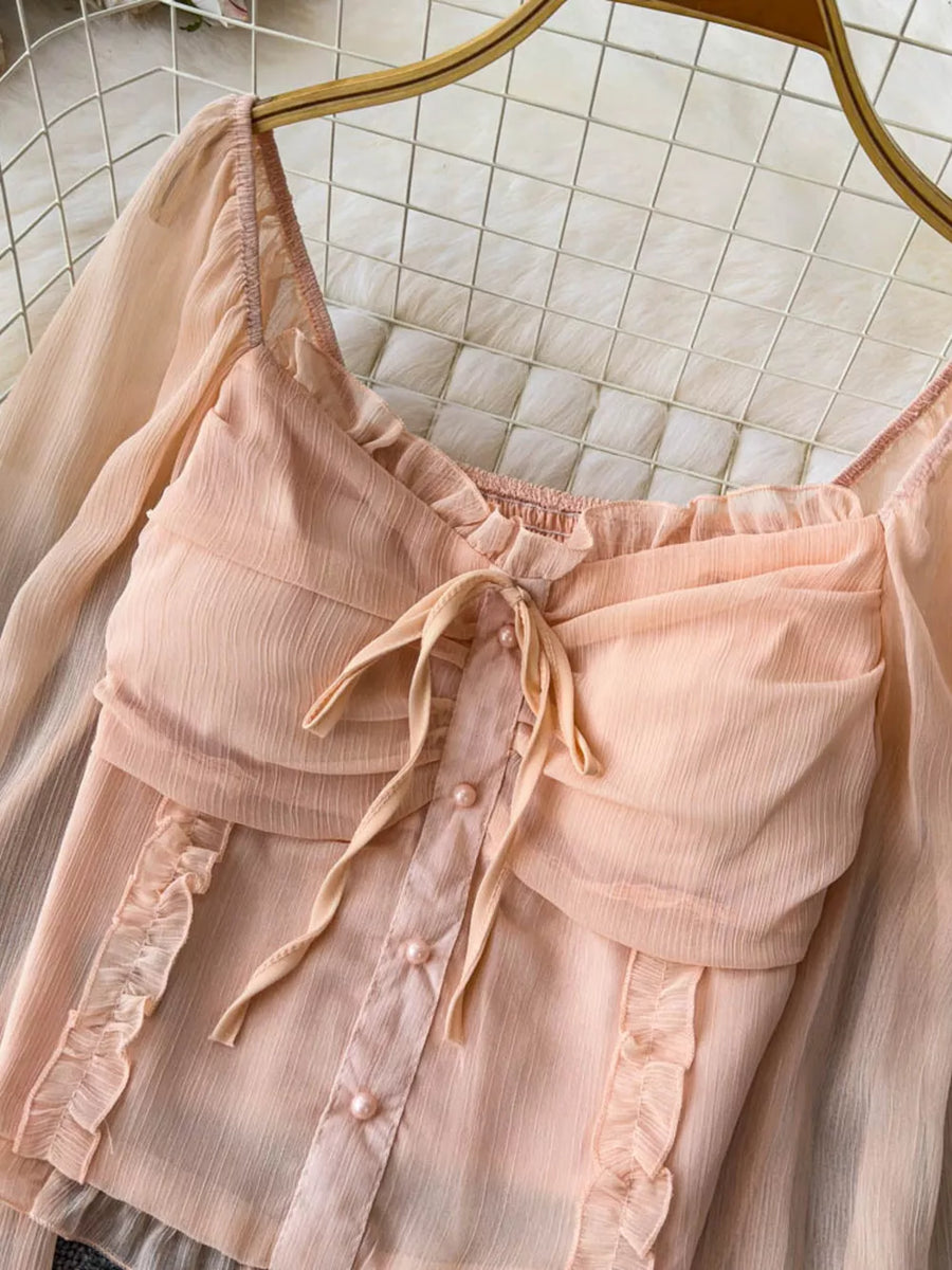 Romantic ruffled sleeve blouse in watermelon pink with a bow and pearl buttons.