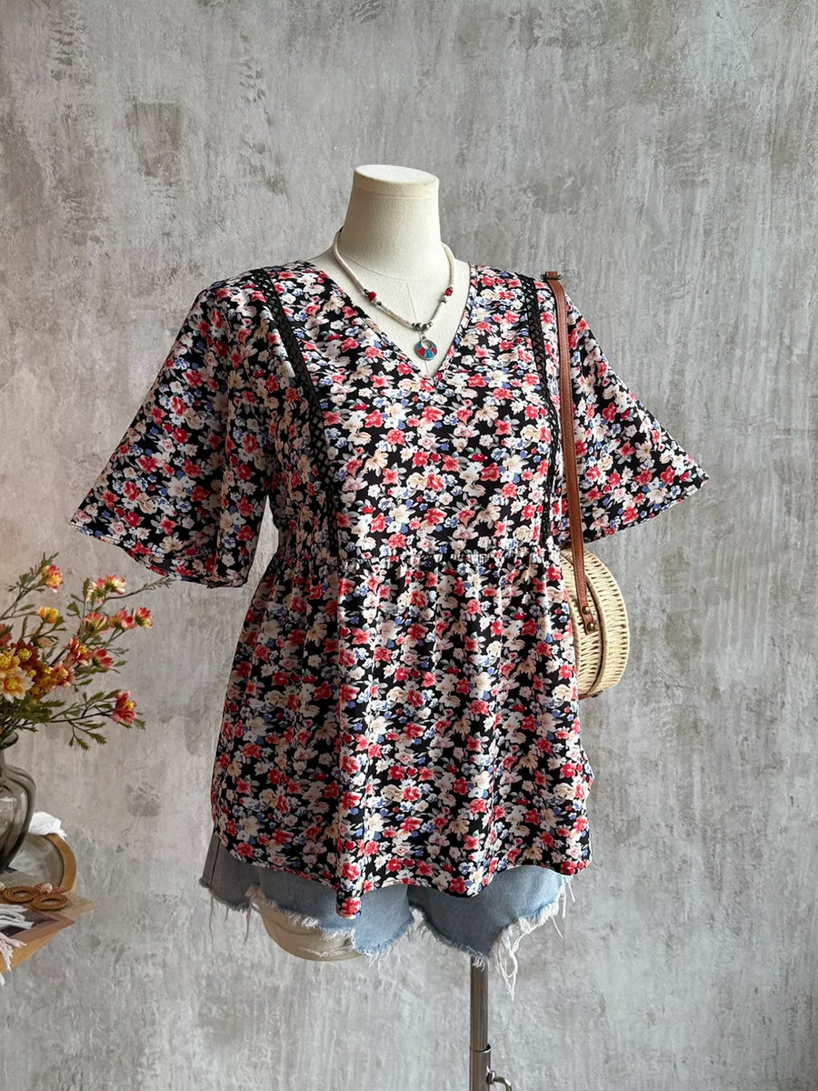 Black floral v-neck blouse with lace detail and short sleeves