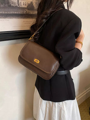 shoulder bag in black with flap closure and small