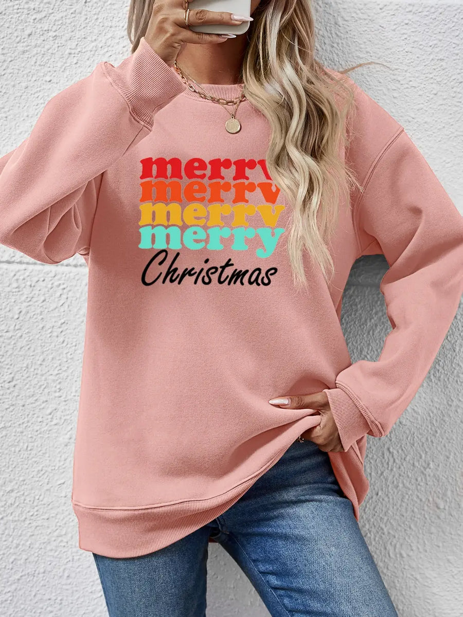 Blush pink crewneck sweatshirt with retro "Merry Christmas" graphic in rainbow colors.
