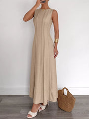 Beige textured maxi dress with elegant silhouette, sleeveless, round neck, and vertical seam details.
