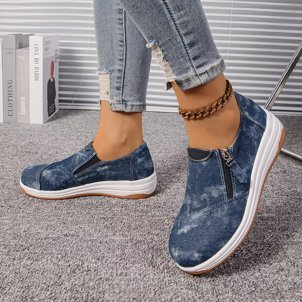 Blue denim slip-on sneakers with side zipper and chunky white sole