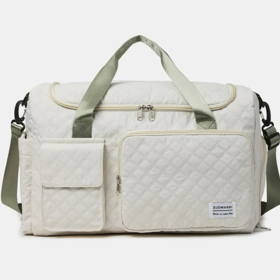 Quilted duffel bag in white with olive green accents and multiple pockets.
