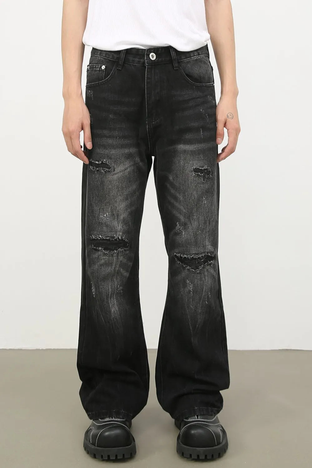 Distressed dark flare jeans with bleach wash and ripped details