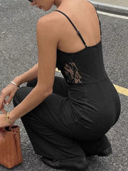 Black lace-trimmed wide-leg maternity romper with spaghetti straps.