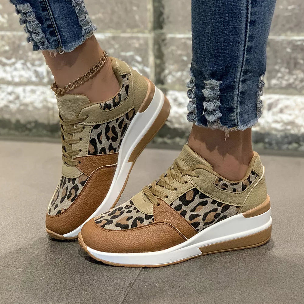 Leopard print lace-up sneakers with brown and tan color-block details and a white sole.