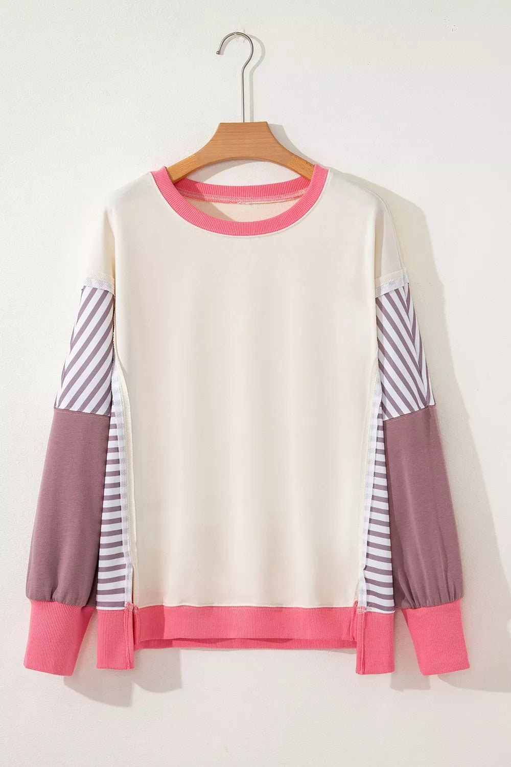 hot pink sweatshirt featuring exposed seam and color-block