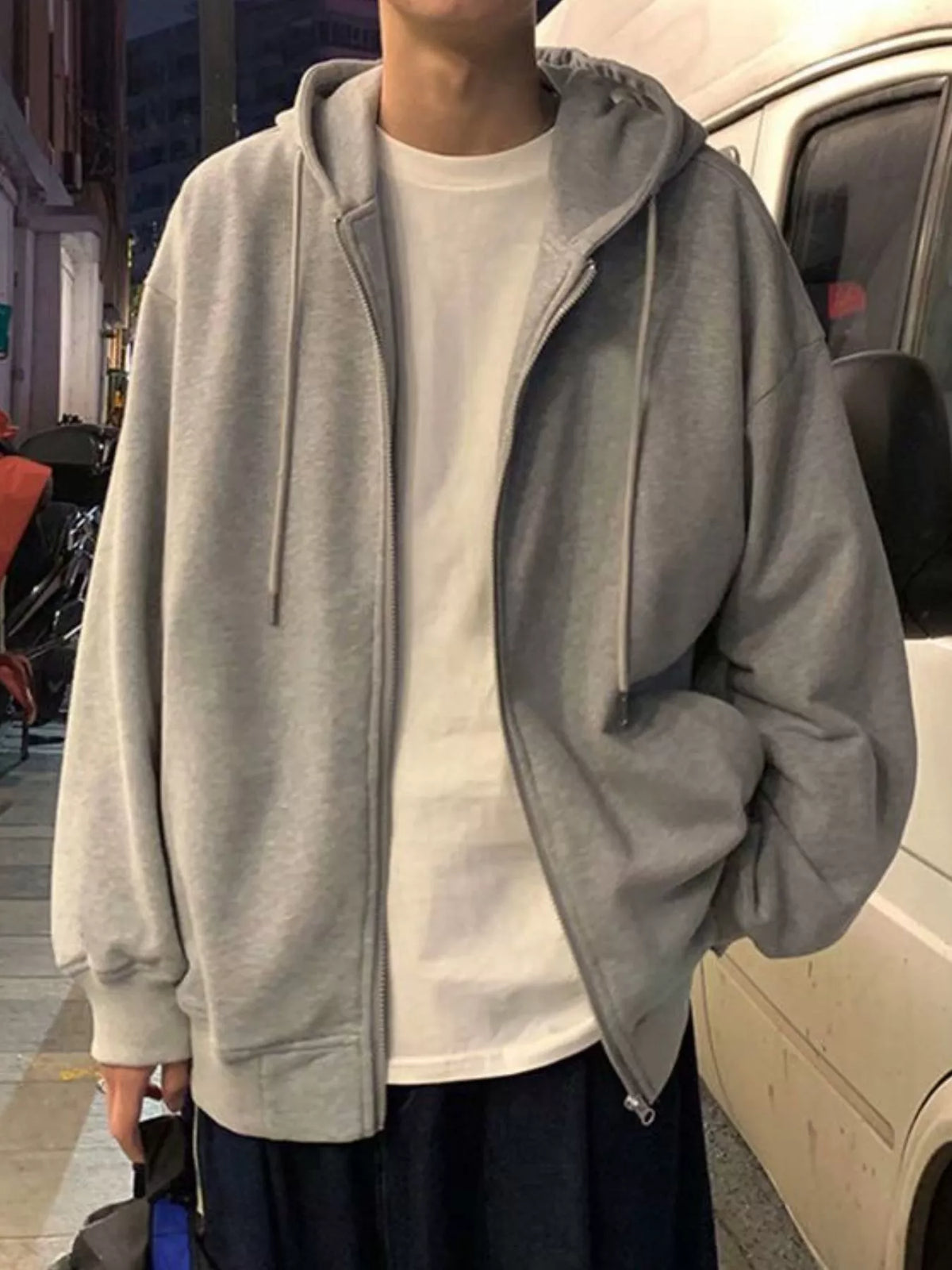 Gray casual zip-up hoodie with drawstring and white t-shirt underneath