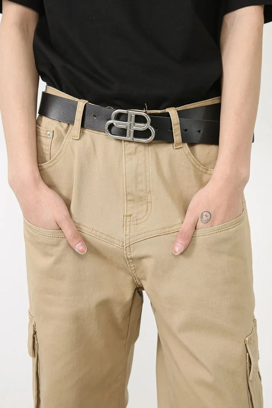 Khaki wide-leg cargo pants with utility pockets and a black belt with a silver buckle.