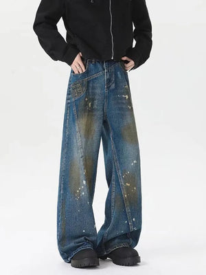 Men's plus-size wide-leg jeans in washed blue denim with paint splatters and distressed details.