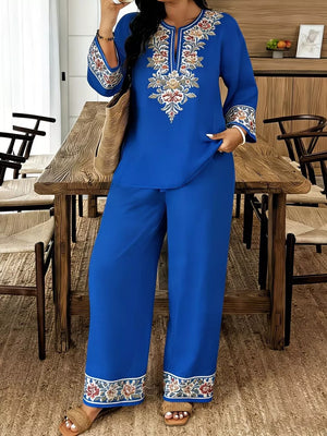 Blue embroidered peasant top with wide-leg pants, floral trim, and bell sleeves.
