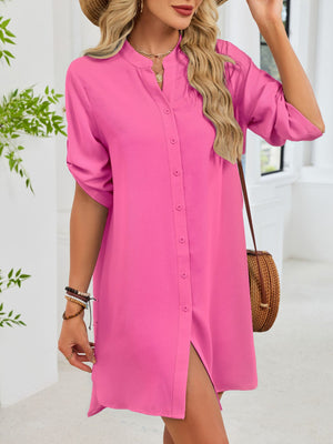 Fuchsia pink button-down shirt dress with band collar and rolled sleeves.