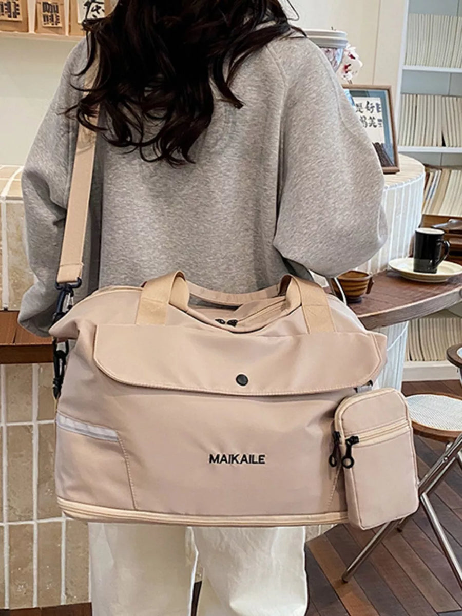Duffel bag in beige nylon with a front flap pocket, side zip pocket, and MAIKAILE logo.