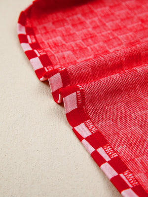 Red and white checkered print shirt with ruffle sleeve detail.