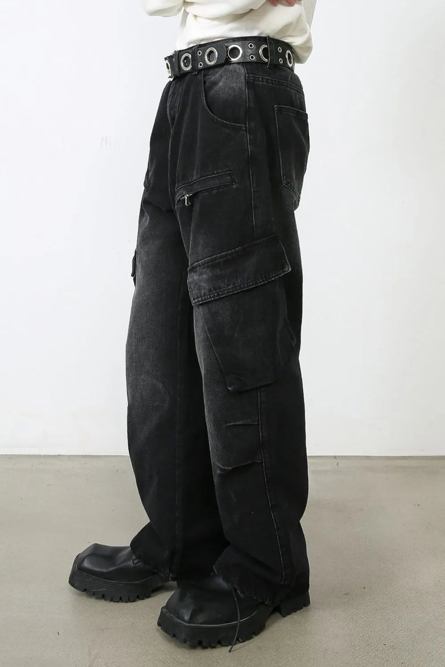Faded black denim cargo pants with multiple pockets and a relaxed fit.