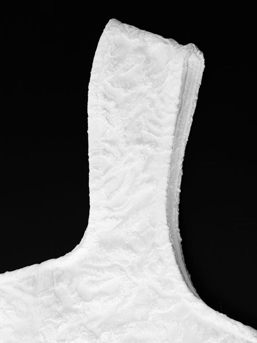 Textured white square neck mini dress detail showing fabric texture and neckline.
