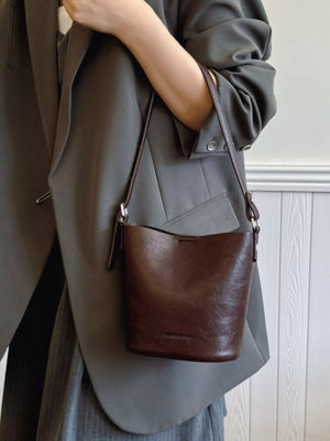 Chocolate leather bucket crossbody bag with adjustable strap