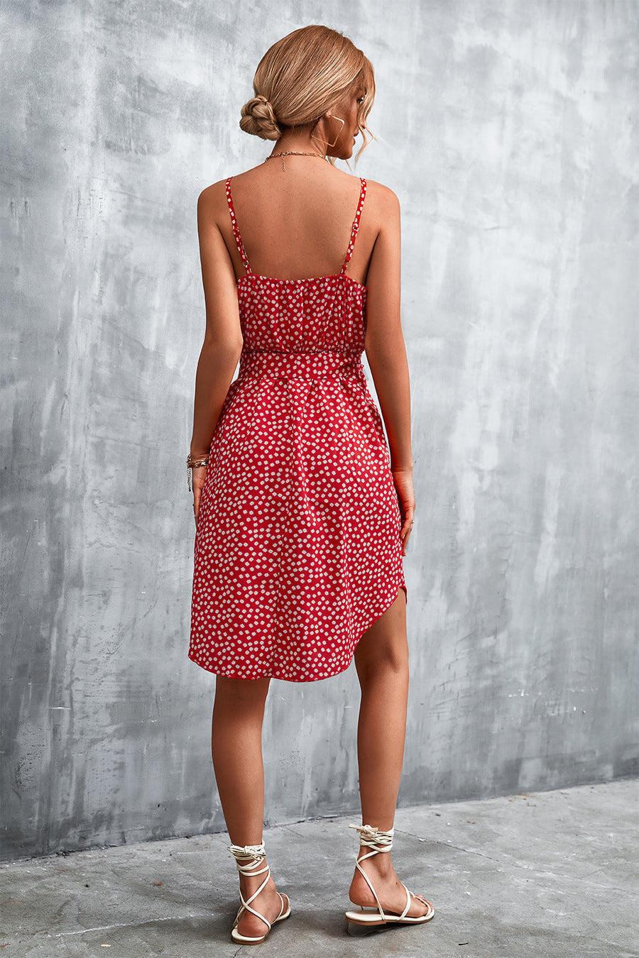 Red daisy print slip dress with spaghetti straps and tie waist, shown from the back.