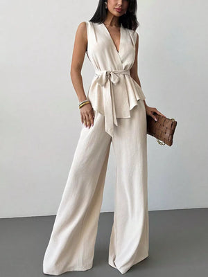 Sleeveless wrap top and wide-leg pants set in cream polyester with a tie waist.