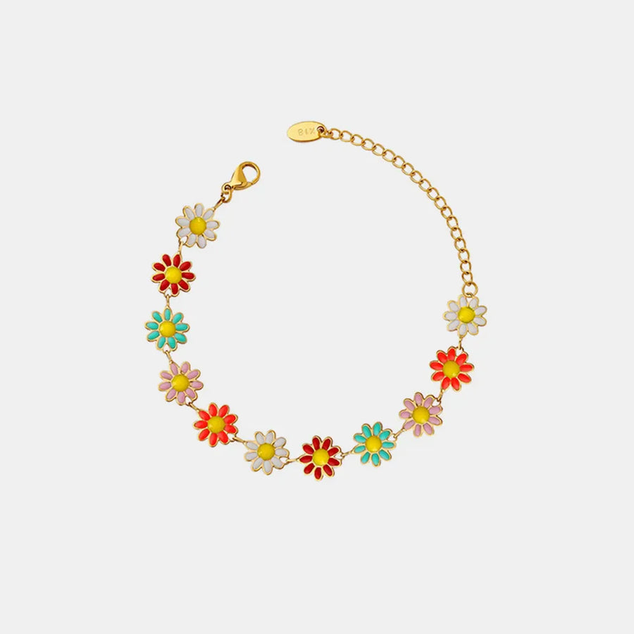 Gold metal bangle bracelet with colorful enamel daisy charms and adjustable chain.