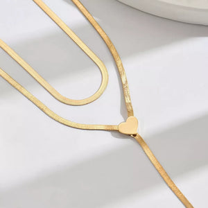 necklace in gold with layered and choker with lariat drop