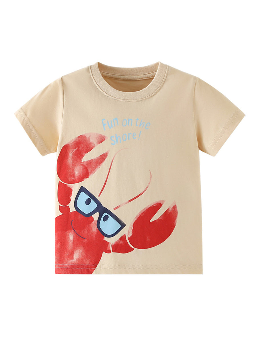 Beige cotton toddler tee with a playful red lobster graphic wearing sunglasses and blue text that says "Fun on the shore!".