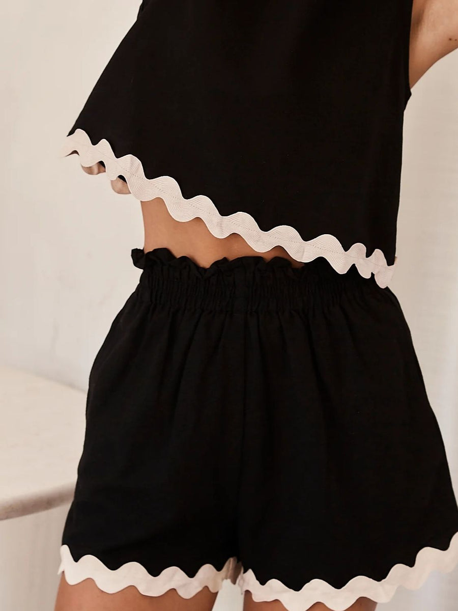 Black linen tank and shorts set with scalloped white trim and smocked waist.