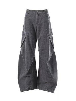 Textured paneled cargo pants in dark gray with a baggy fit and large side pockets.