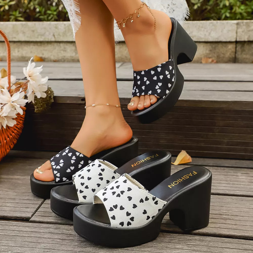Playful heart print block heel sandals in black/white and gray/white. Comfortable platform slides.