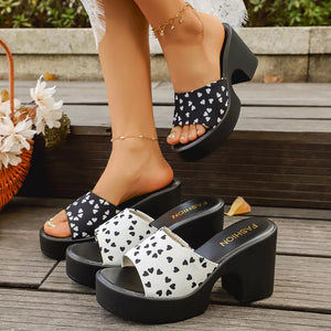 Playful heart print block heel sandals in black/white and gray/white. Comfortable platform slides.