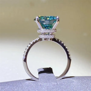 Radiant teal moissanite pavé ring in silver with a cushion-cut center stone.