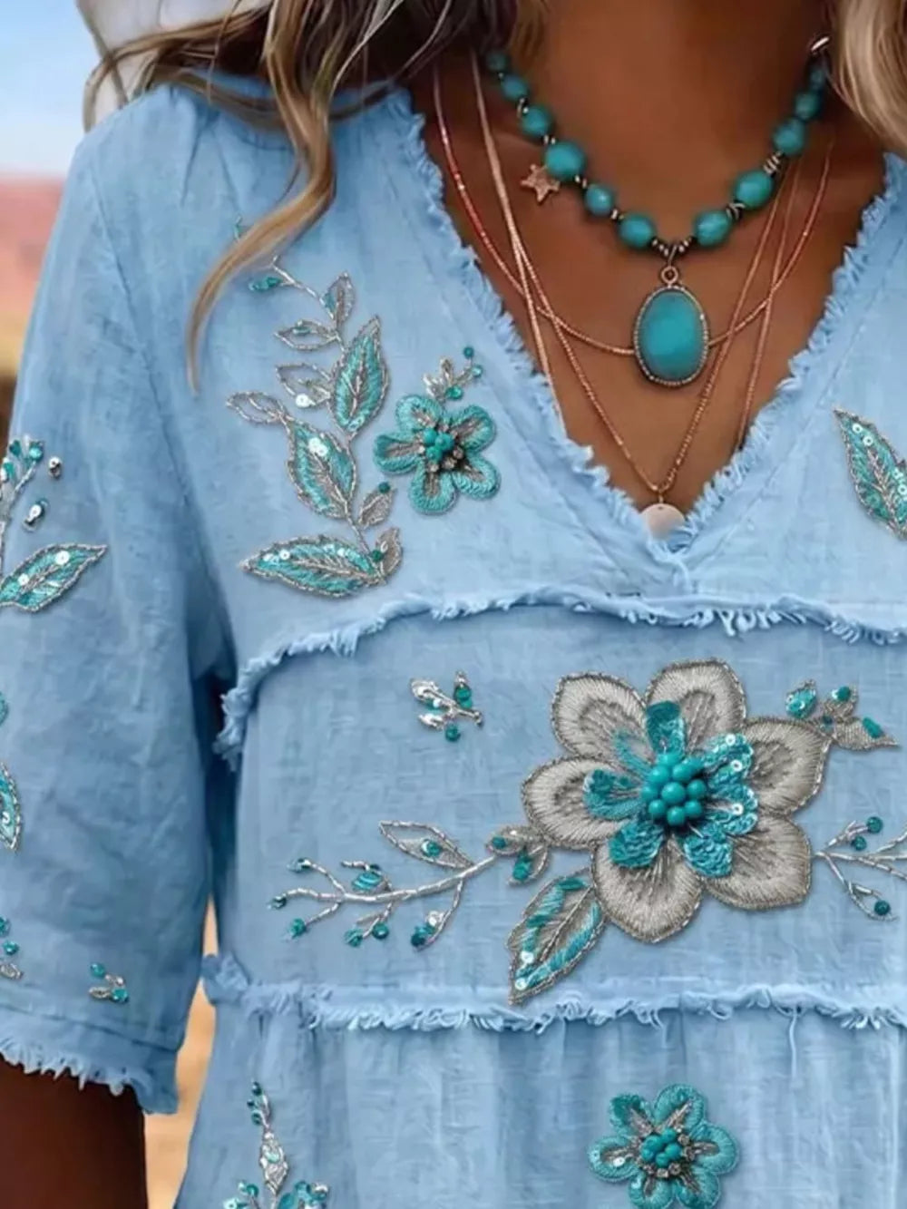 teal blouse featuring tiered and floral