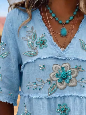 teal blouse featuring tiered and floral