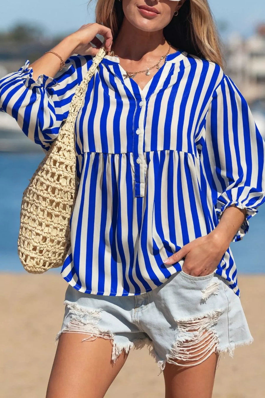Blue and white striped button-down shirt with balloon sleeves and a tiered hem.