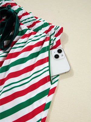 Velvet Ribbon Knot Pajama Set in Stripe pattern, showing pocket detail with phone.