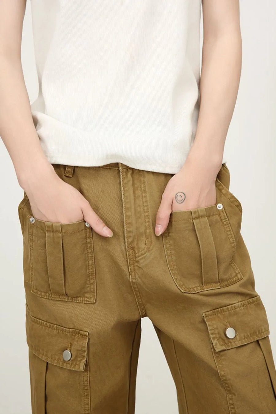 Khaki cargo trousers with wide legs and pleated patch pockets.
