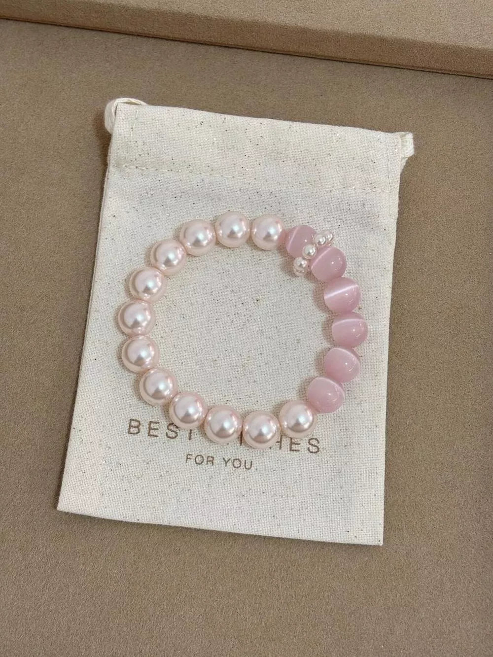 bracelet in light pink featuring beaded and fitted fit