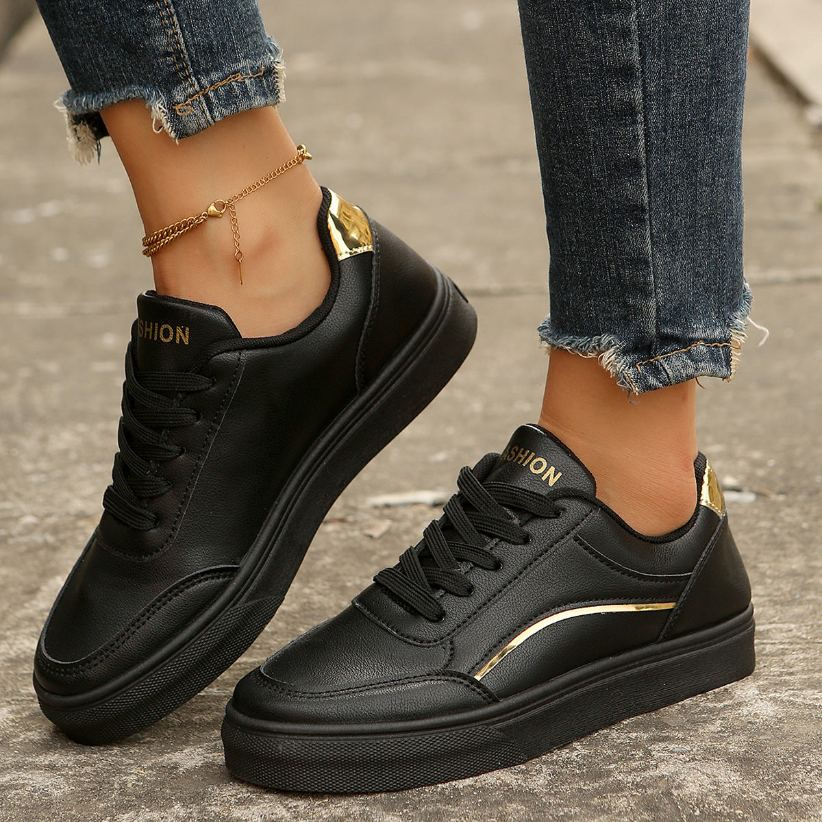 Black lace-up casual sneakers with gold accents and "Fashion" detail.