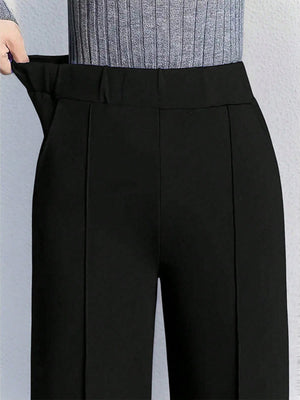 Black high-waisted wide leg cotton trousers with pockets and a comfortable elastic waistband.