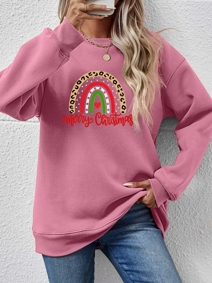 Blush pink crewneck sweatshirt with rainbow Christmas graphic and leopard print detail.