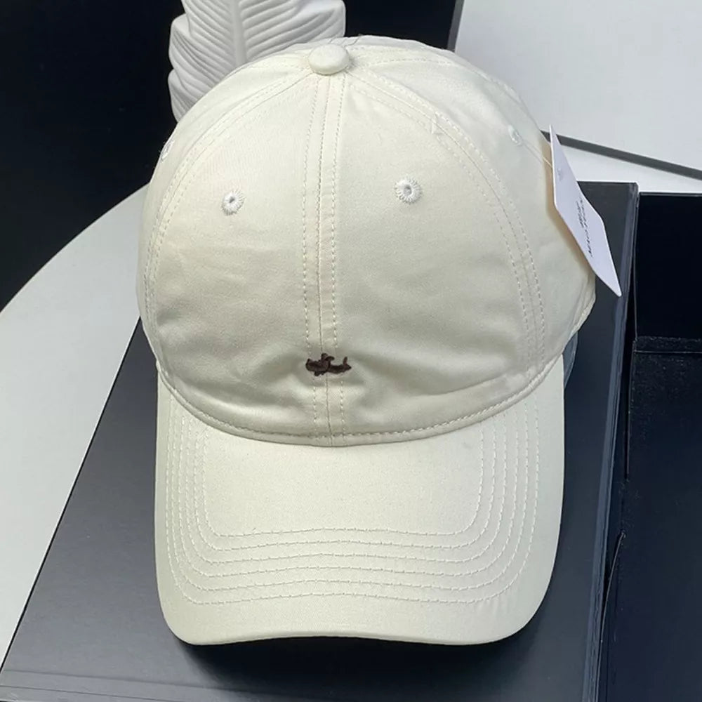 Cream white cotton baseball cap with embroidered detail and ventilation eyelets