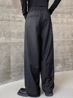 Black men's wide-leg dress pants with elastic waist and back pockets.