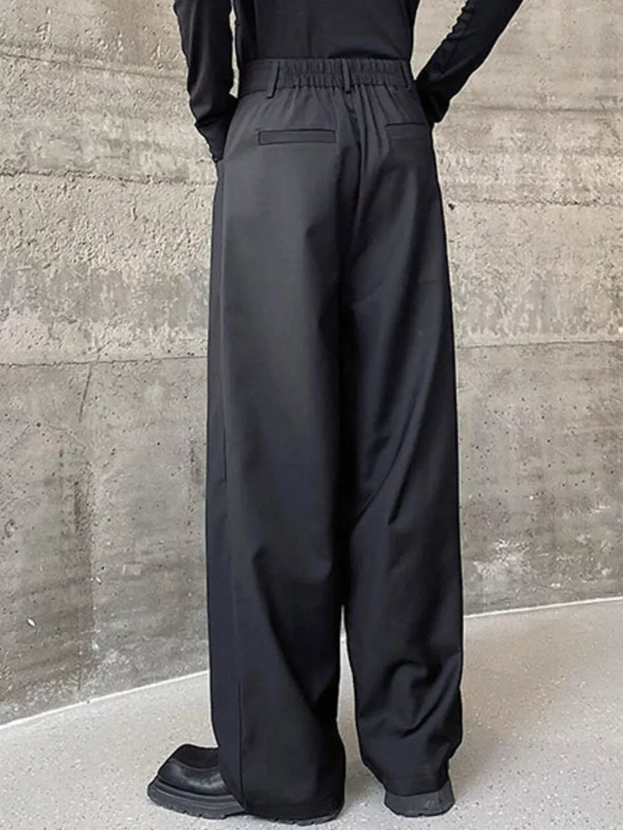 Black men's wide-leg dress pants with elastic waist and back pockets.