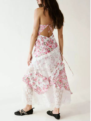 Floral lace maxi dress with ruffles and open back, featuring a pink floral print and white lace trim.